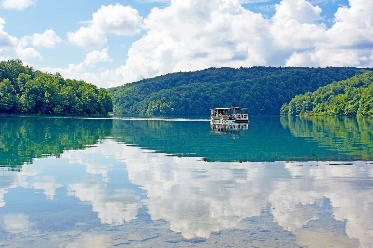 Electric boat crossing emerald Lake Kozjak on a Plitvice Lakes National Park tour, Croatia
