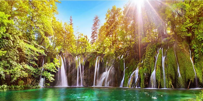 Boardwalk winding past waterfalls on a budget Plitvice Lakes National Park tour from Zagreb, Croatia