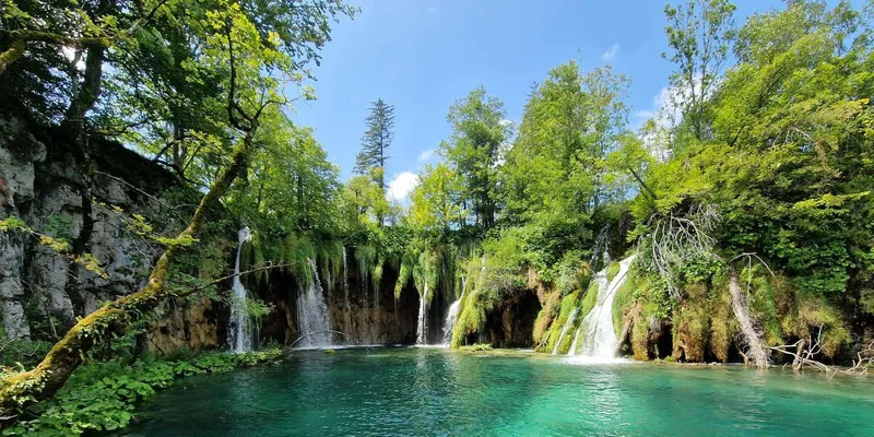 Electric boat crossing a lake on a Plitvice Lakes National Park tour from Zadar, Croatia