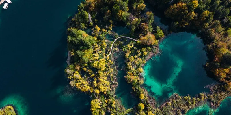 Turquoise lake framed by cliffs on a self-guided Plitvice Lakes National Park tour from Split, Croatia